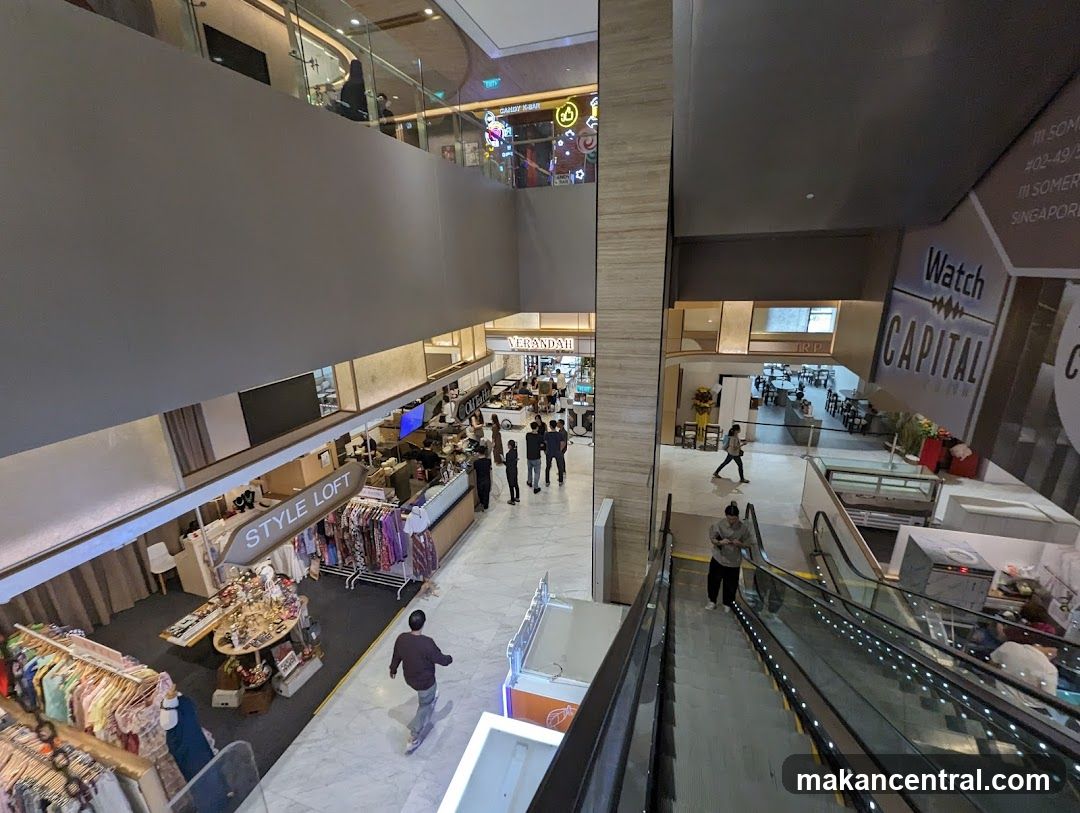 Shopping mall interior with escalators and shops