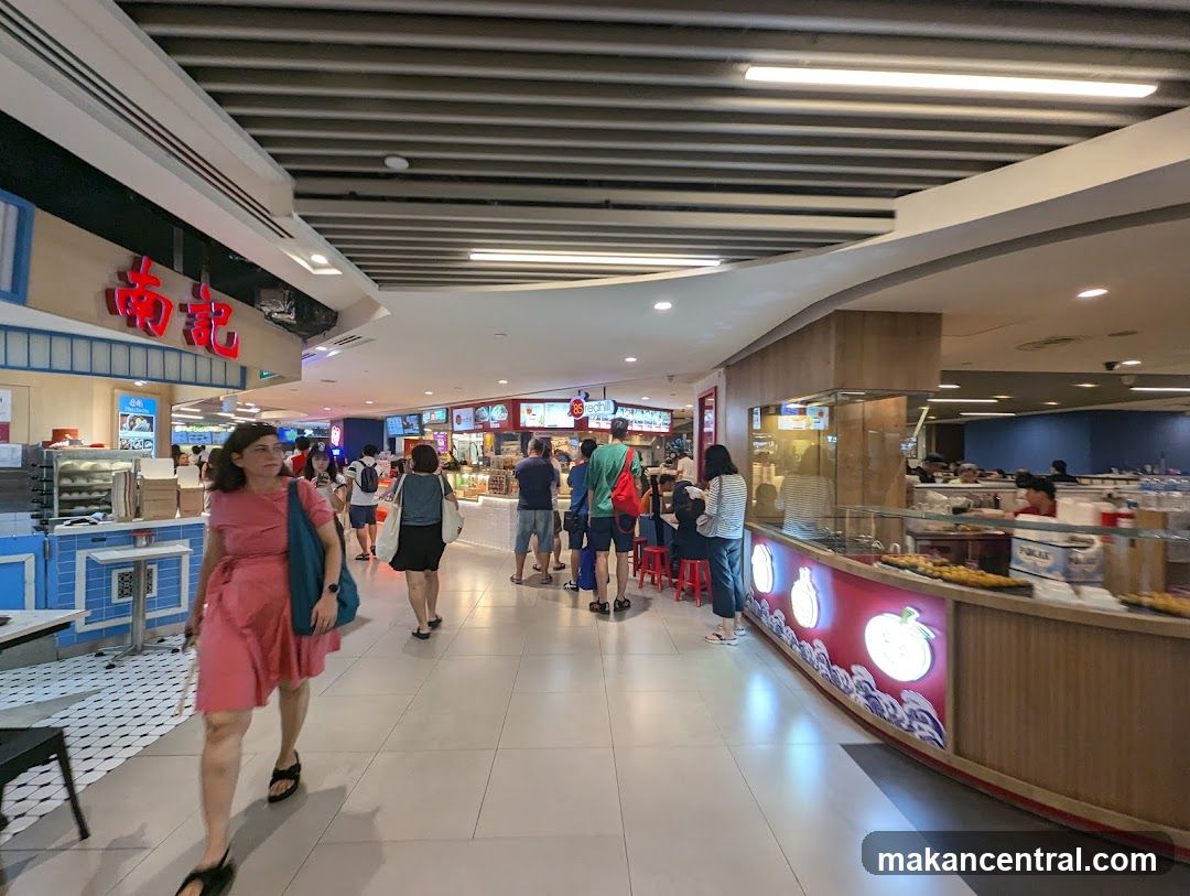 Food court with various stalls and shoppers