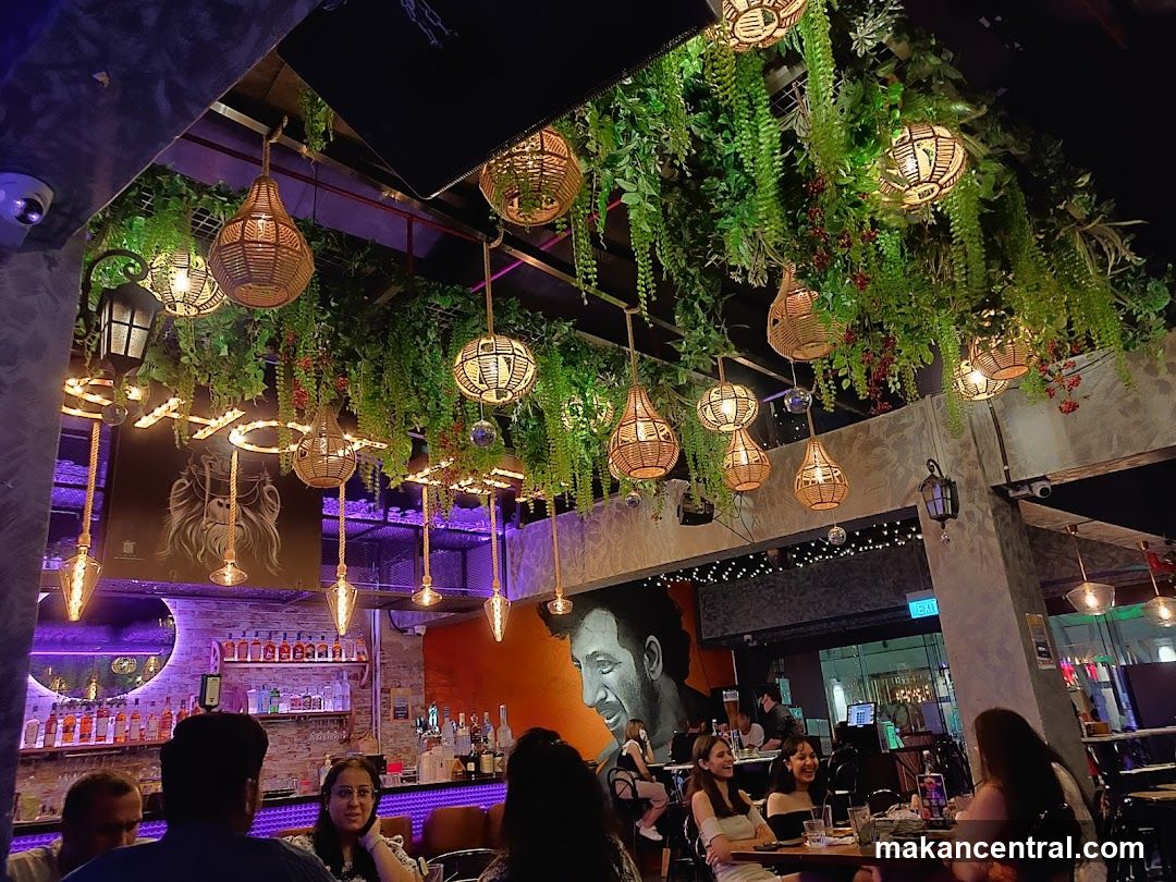 Restaurant Interior with Hanging Lights and Greenery