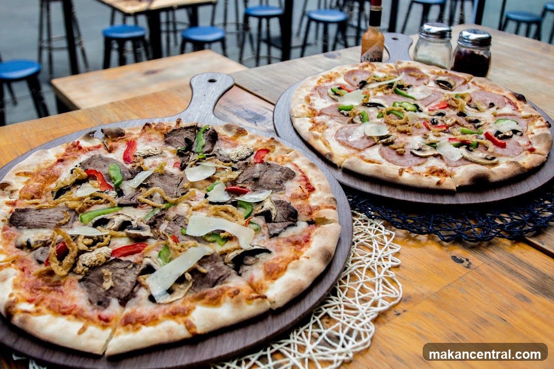 Two Pizzas on Wooden Table