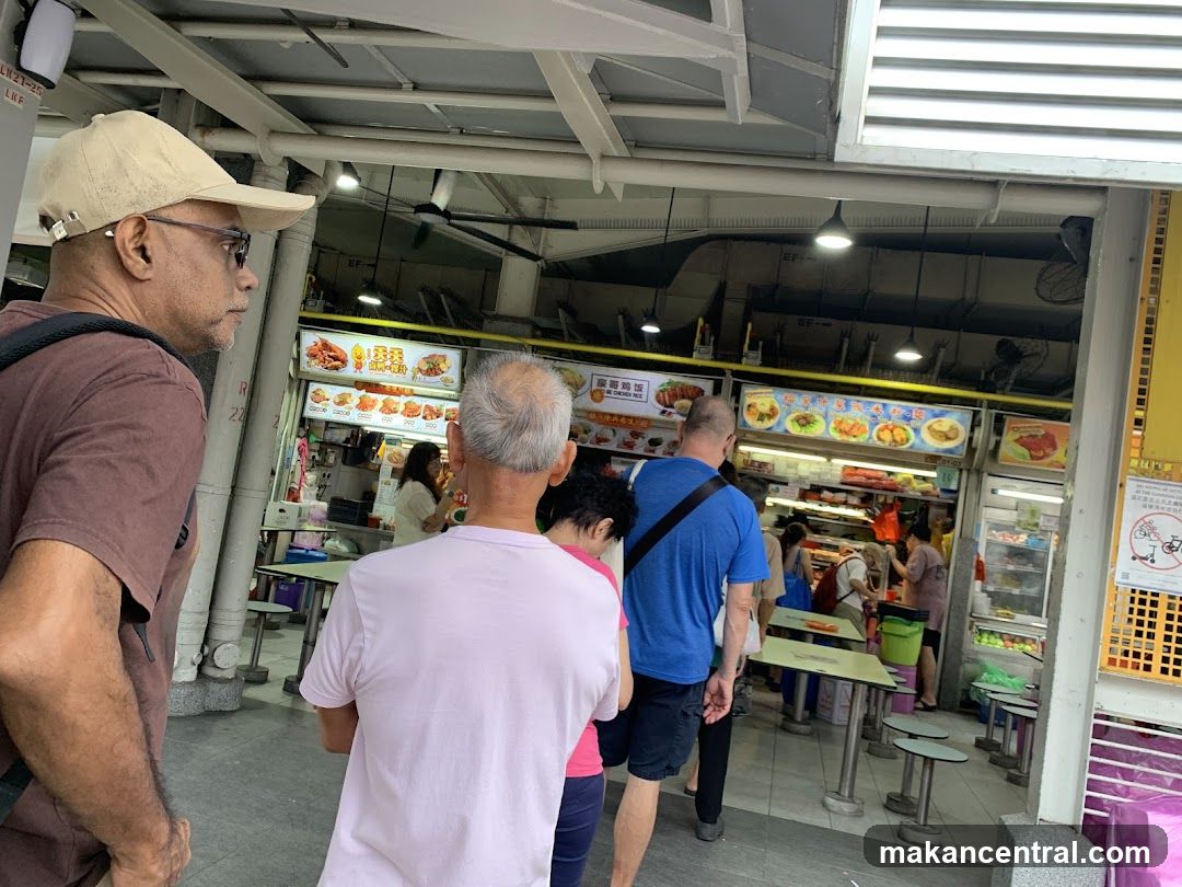 People queuing at a food stall