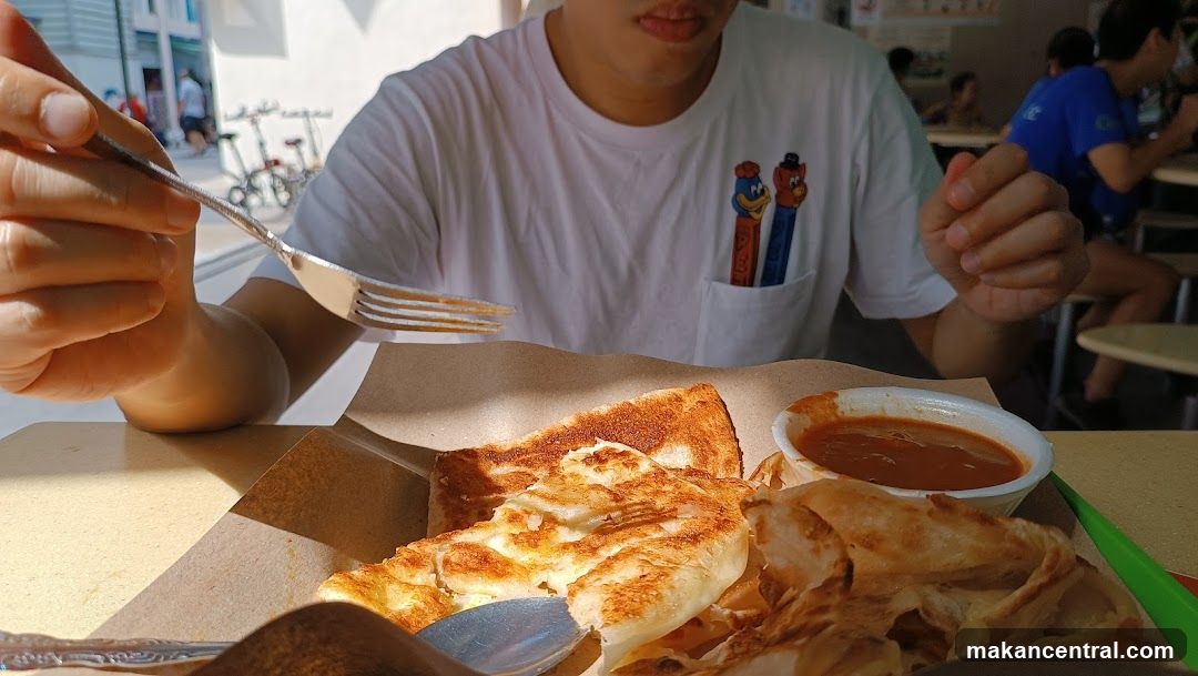 Person eating Roti Canai