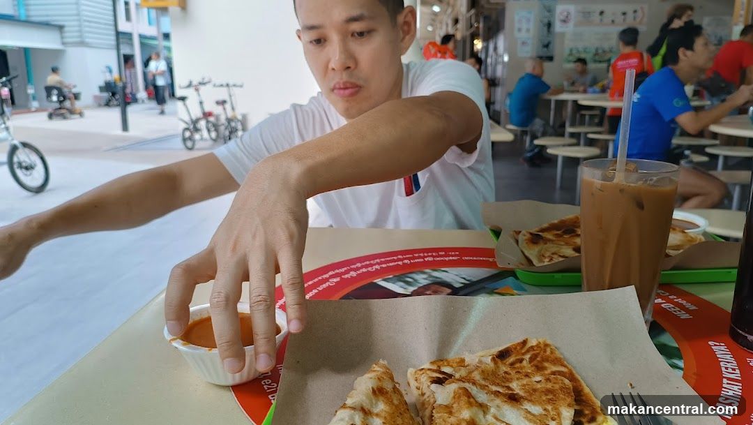 Man eating at a food stall
