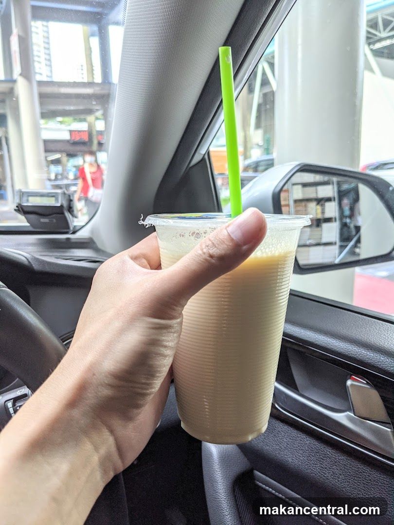 Hand holding a beverage in a car