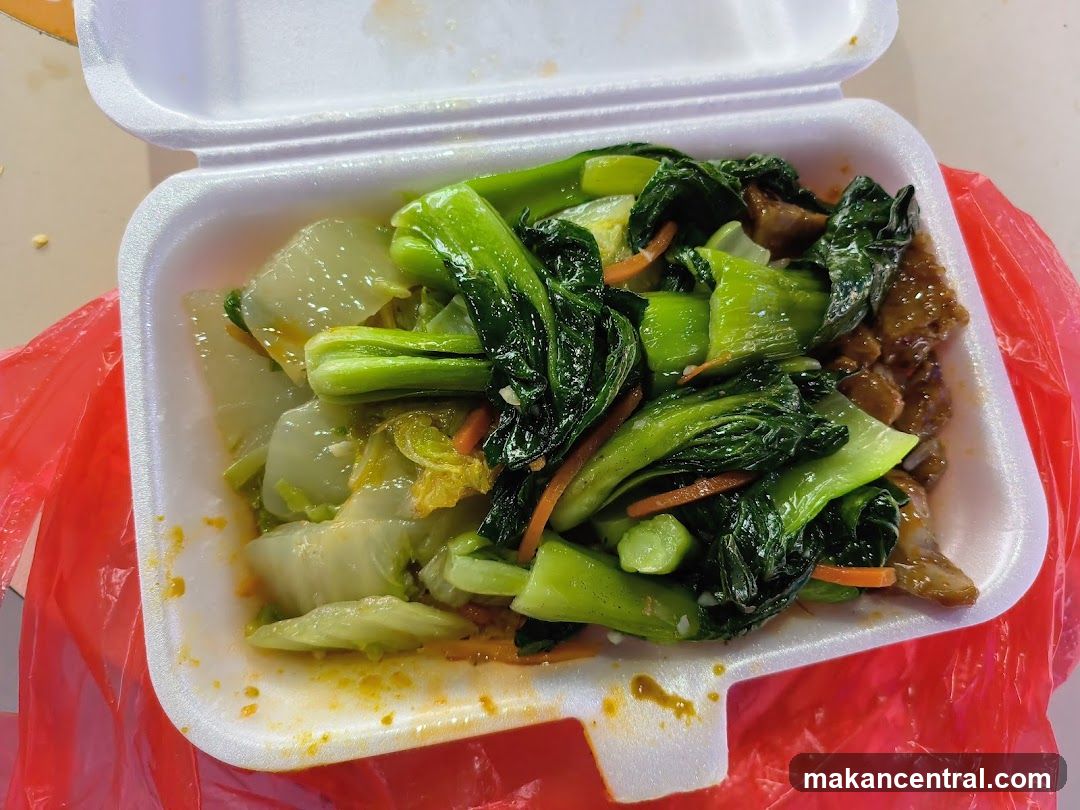 Styrofoam container of stir-fried vegetables and meat