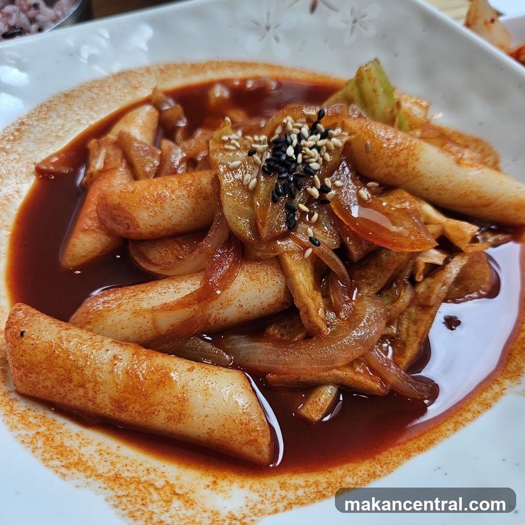 Spicy Rice Cakes with Onions and Sesame Seeds