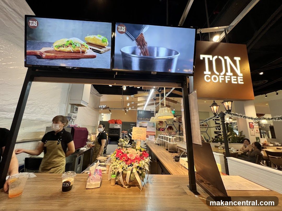 Coffee shop counter with staff and signage