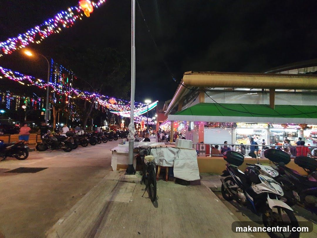 Night Market Scene with Motorcycles and Lights
