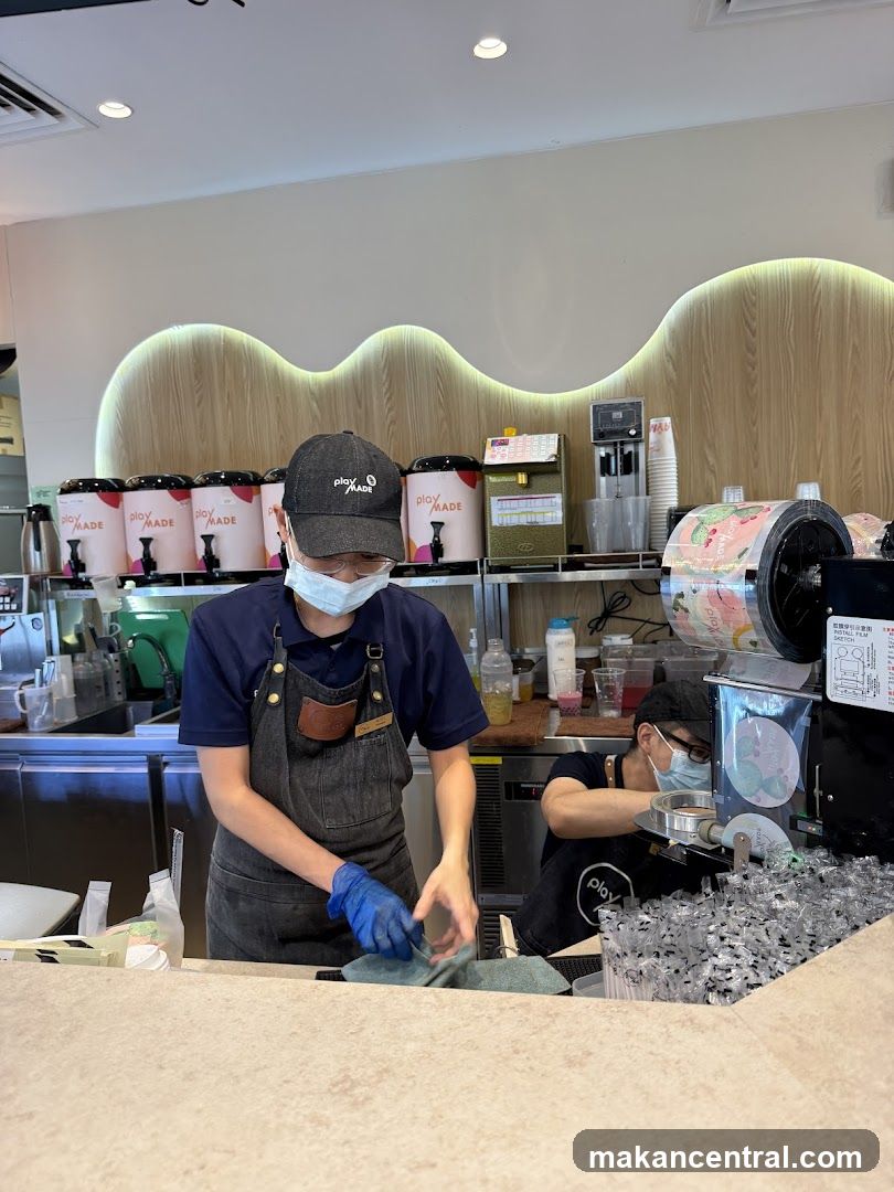 Beverage Shop Staff Preparing Drinks