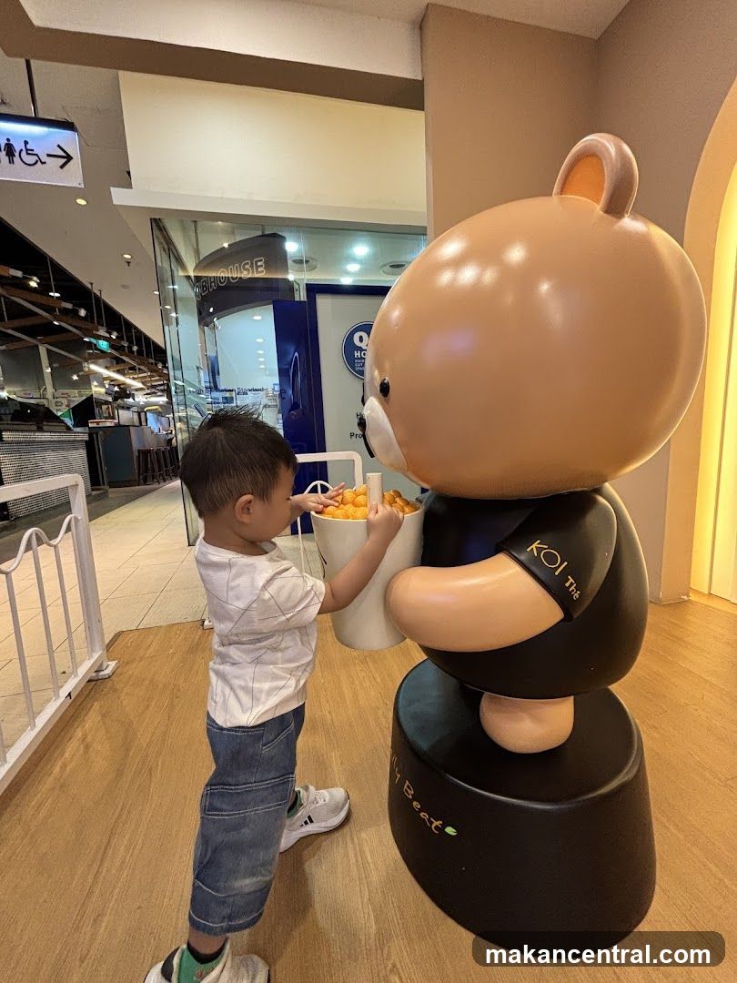 Child interacting with a large bear statue