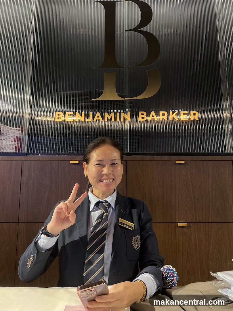 Employee Posing with Benjamin Barker Logo