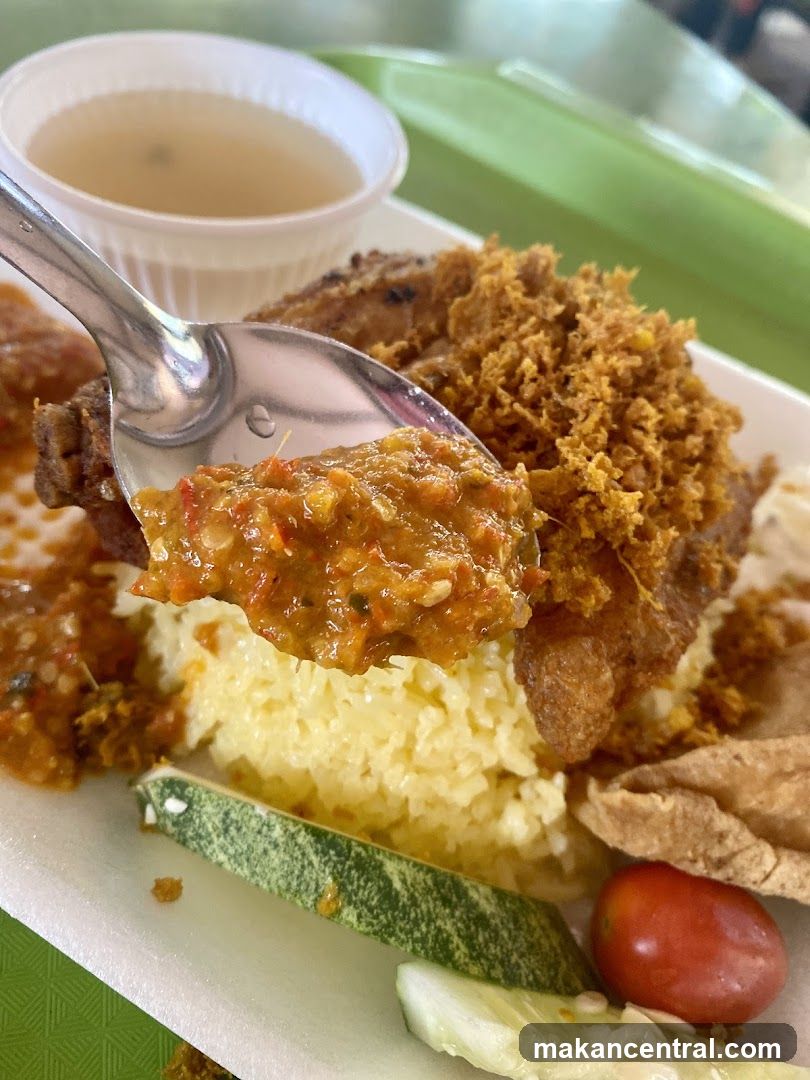 Spoonful of Spicy Rice and Fried Chicken