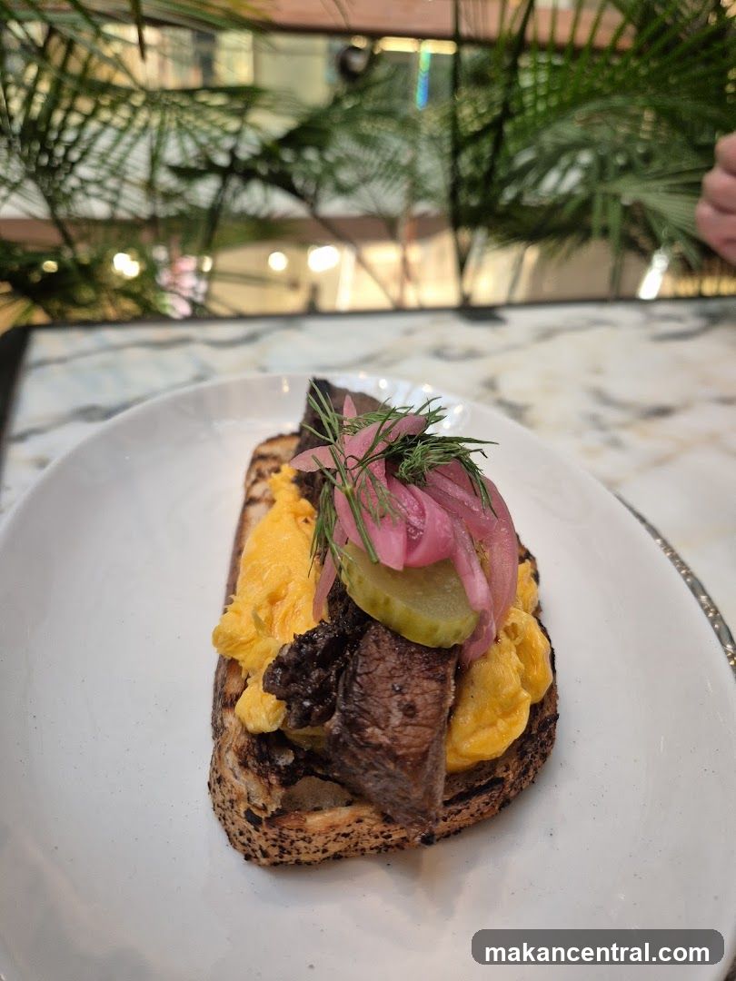 Open-faced sandwich with scrambled eggs and meat