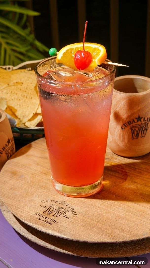 Cocktail with Orange and Cherry Garnish