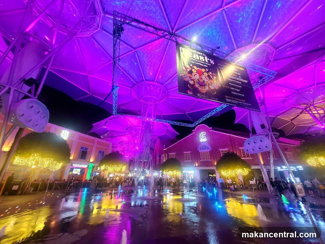 Outdoor plaza with fountains and lights