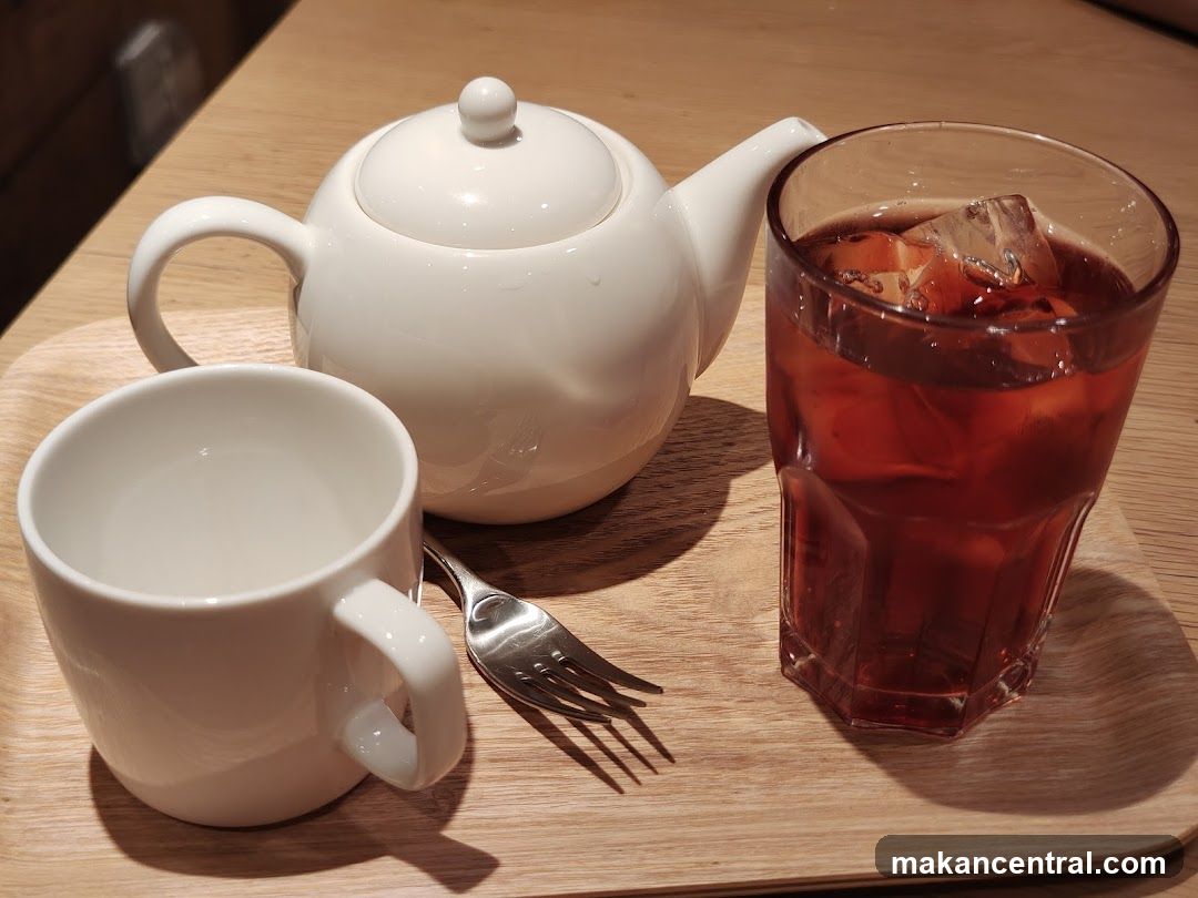 Tea set and iced drink on a tray