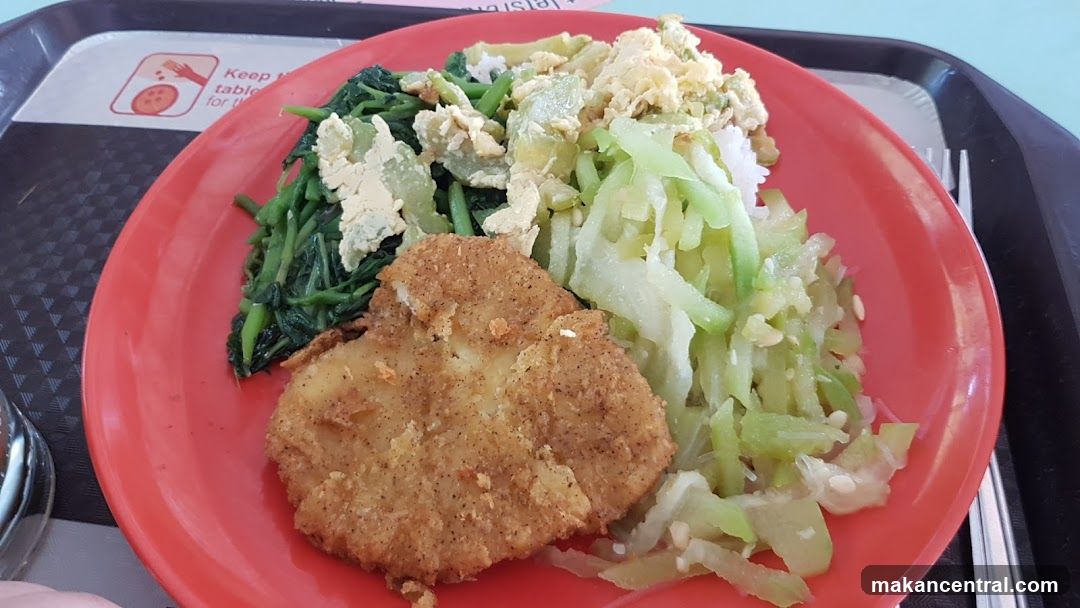 Plate of food with fried fish and vegetables