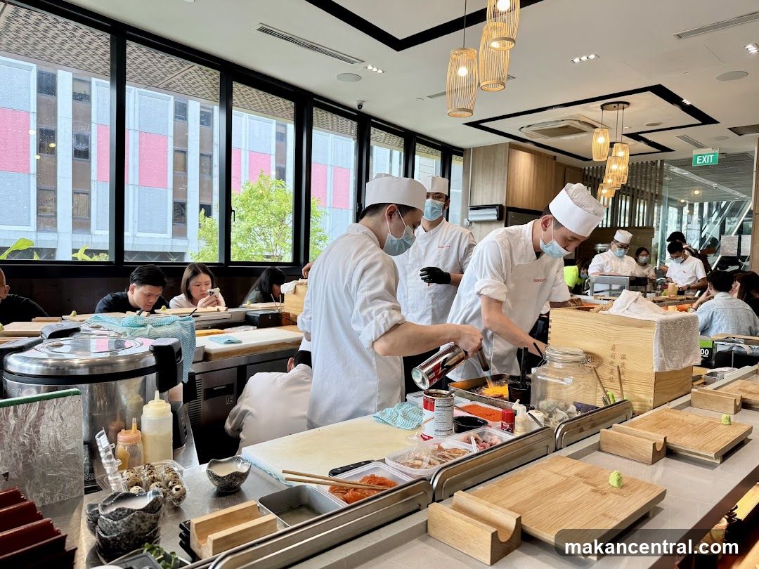 Chefs preparing food at a sushi bar