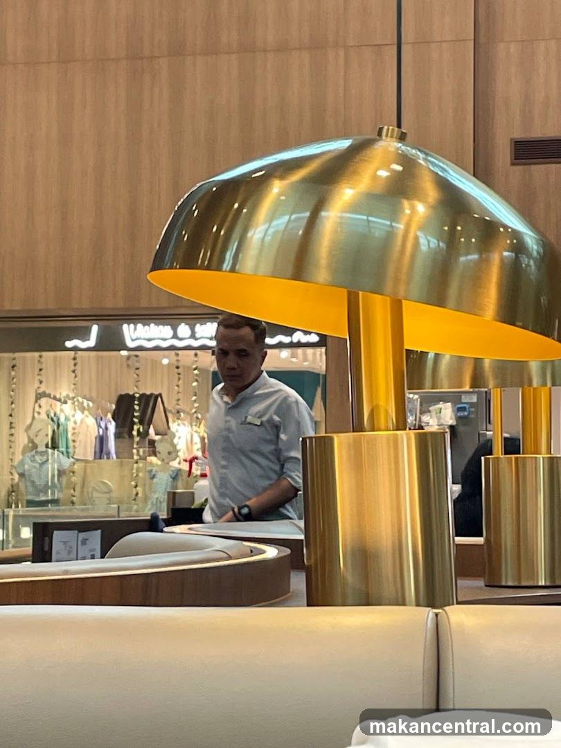 Man in a light blue shirt behind a counter
