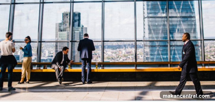 People in a modern office with a city view