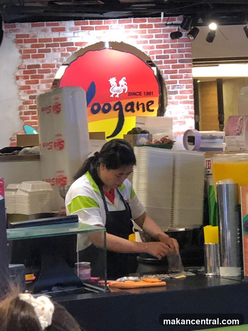 Woman grating food behind a counter