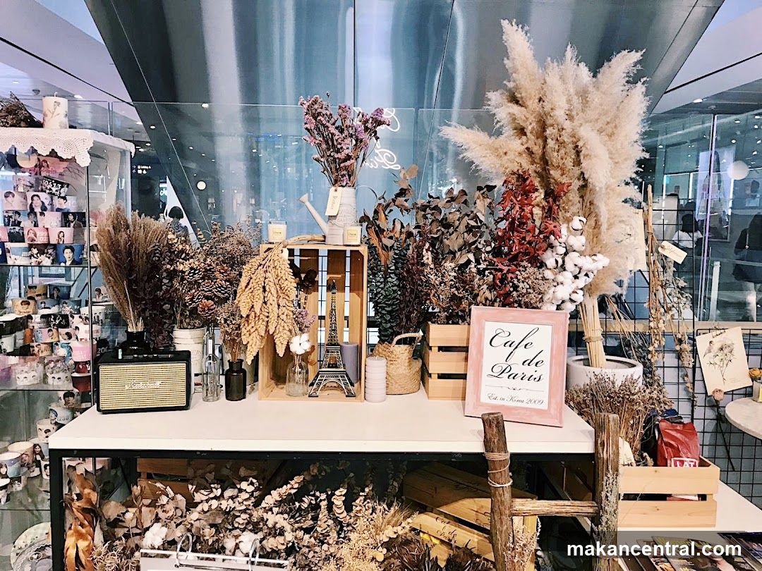 Dried floral display with "Cafe de Paris" sign