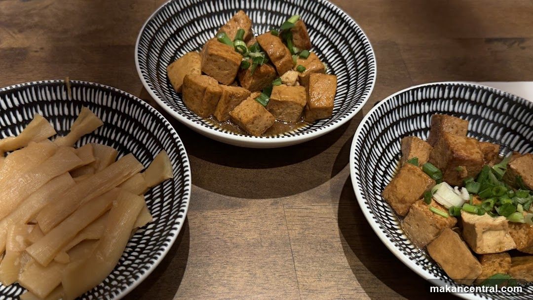 Three bowls of food on a wooden table