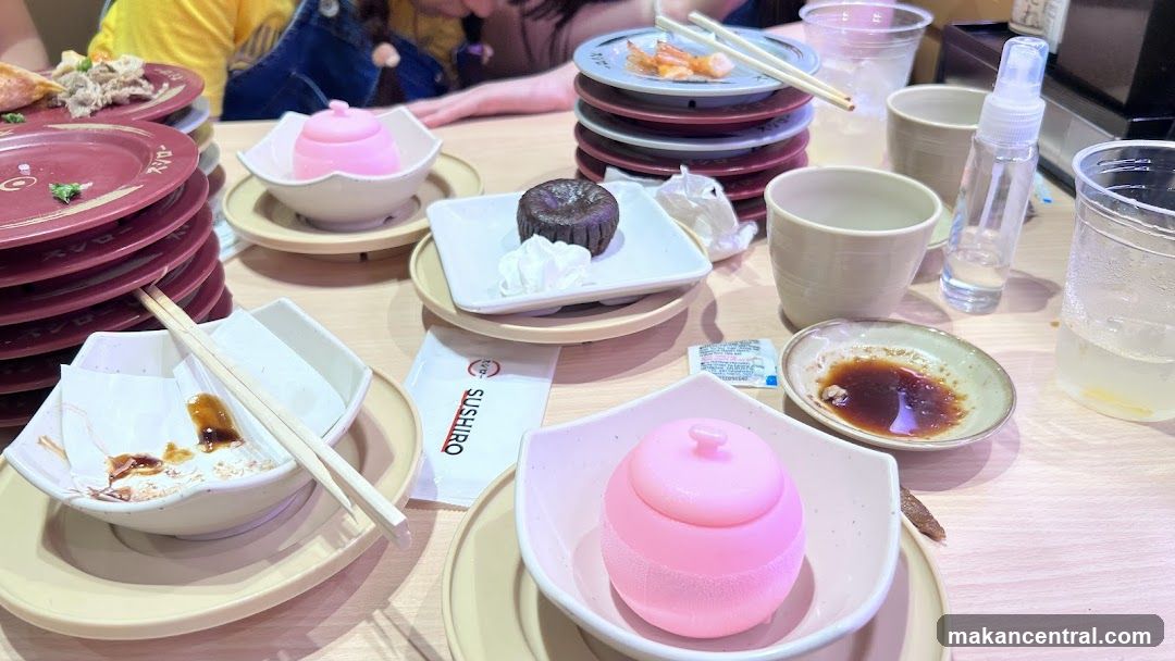 Table with Sushi Plates and Desserts