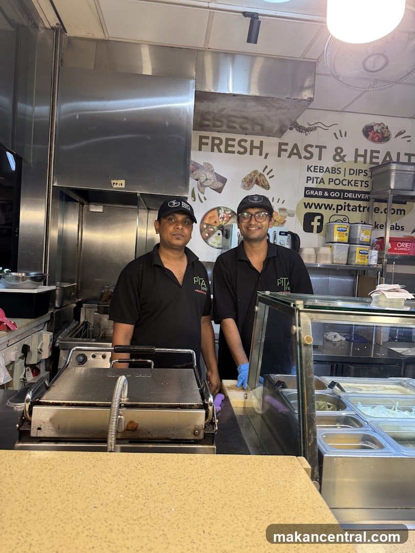 Two men working in a food establishment