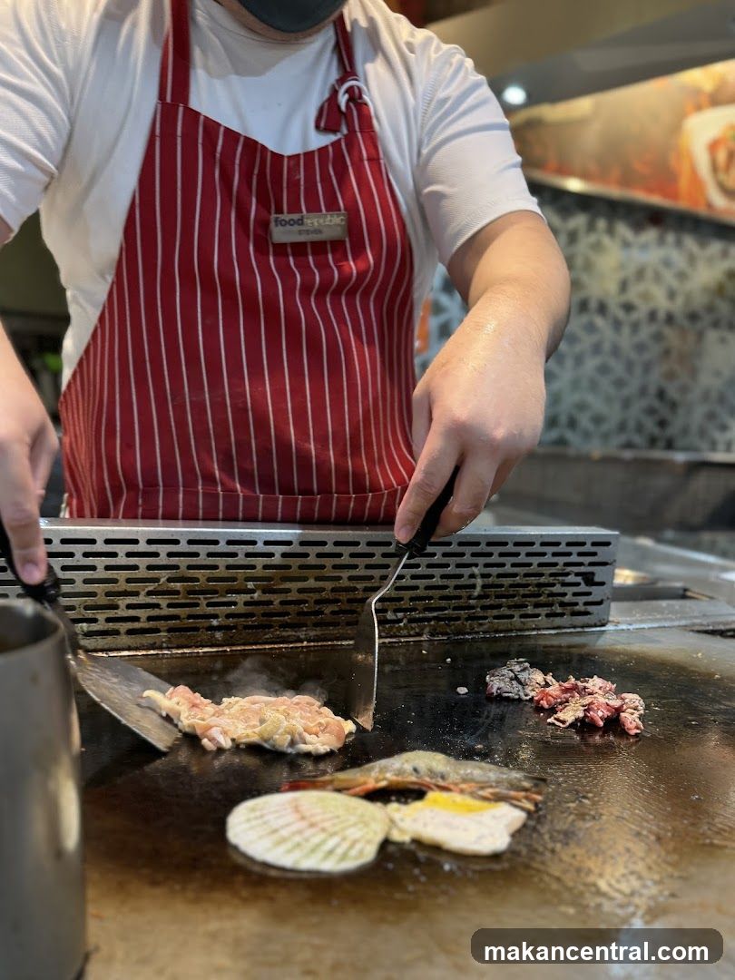 Chef cooking seafood and meat on a grill