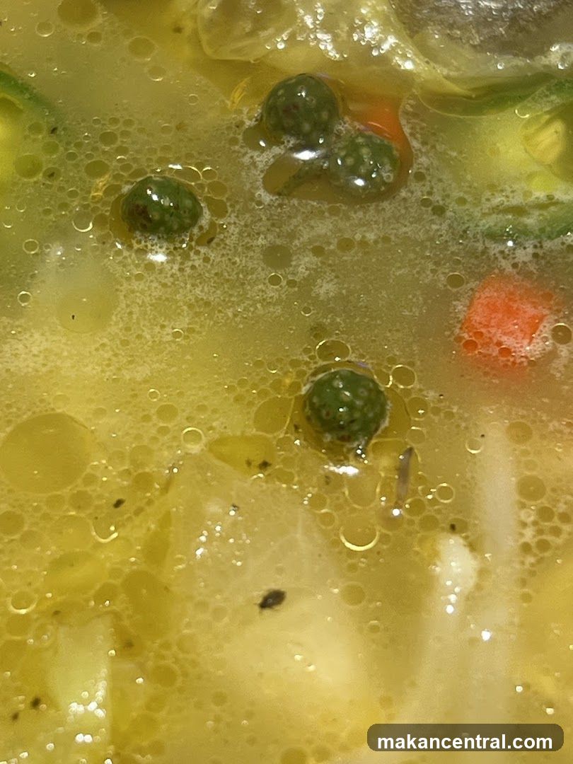 Close-up of Soup with Peas and Carrots