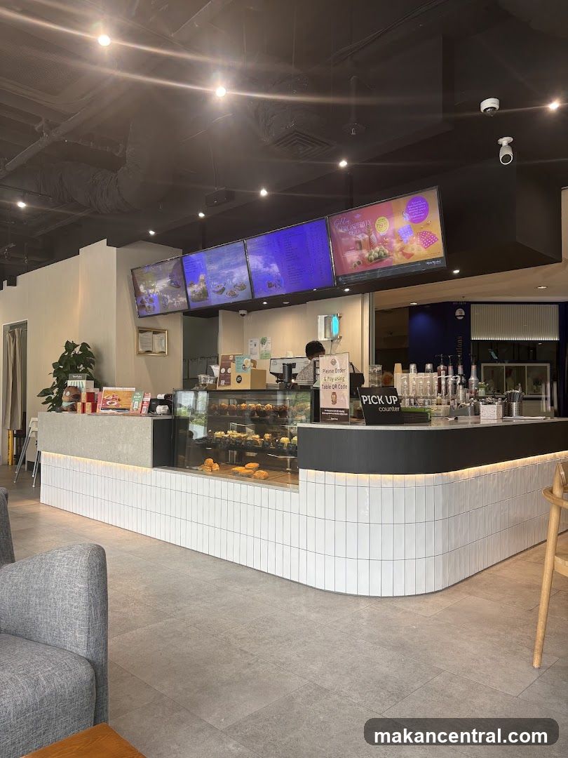 Cafe Counter with Pastries and Digital Menus