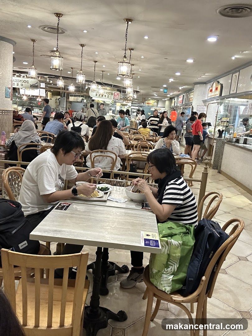 People eating at tables in a food court