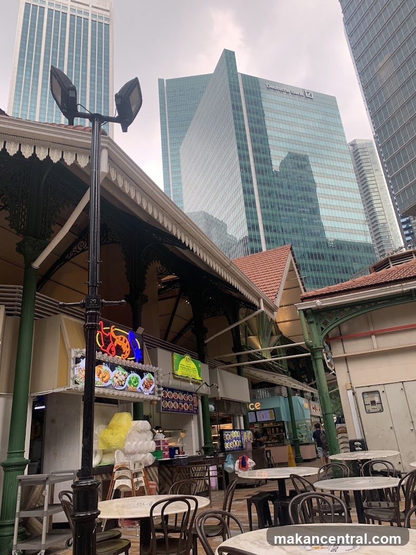 Outdoor Food Stalls with Cityscape Background