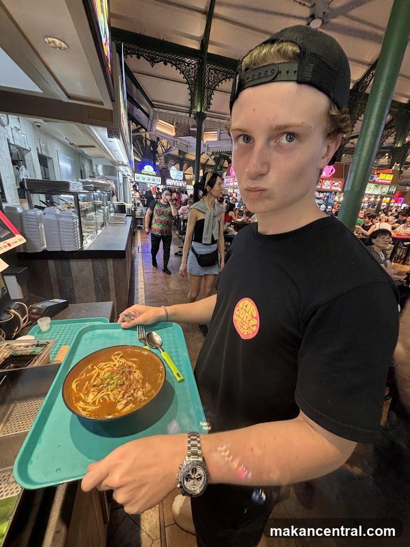 Person holding a bowl of noodles