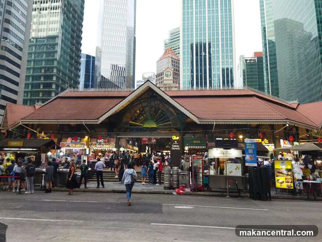 Outdoor Food Stalls with Cityscape Background