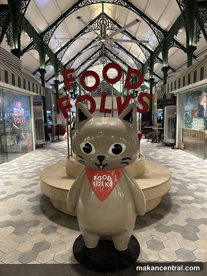 Cat statue with "Food Folks" signage