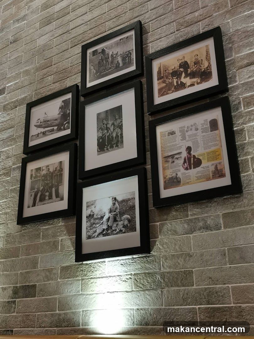 Framed historical photographs on a brick wall