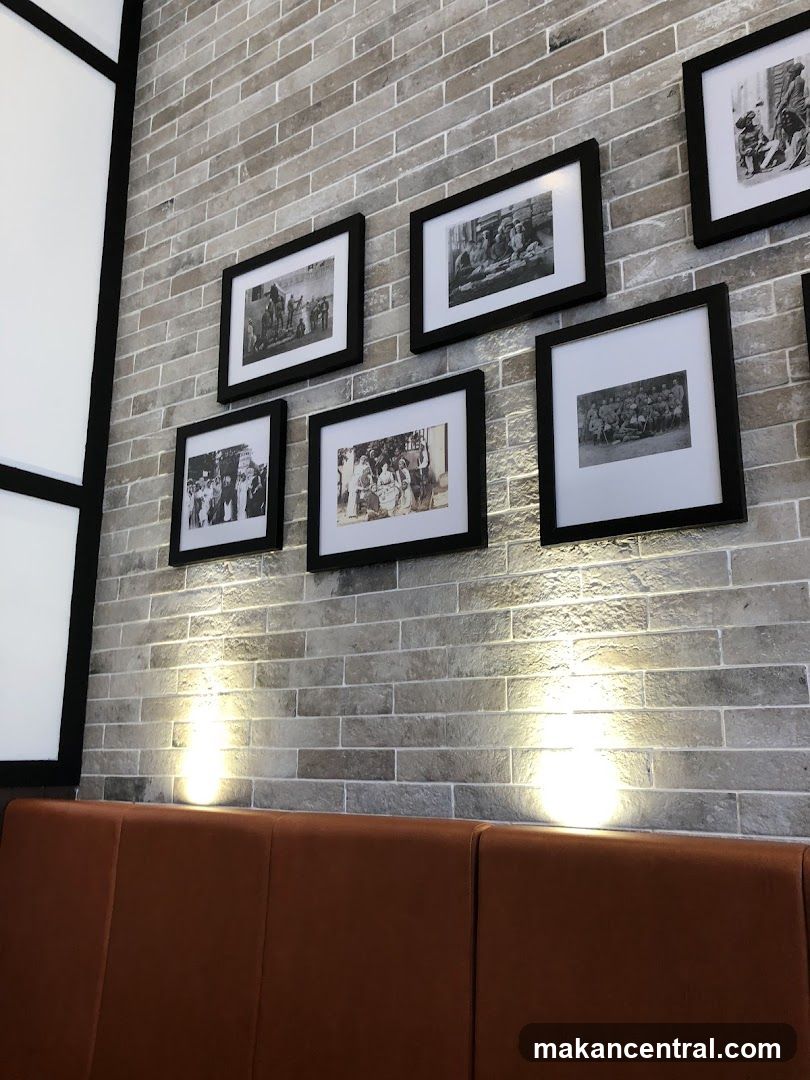 Framed historical photographs on a brick wall