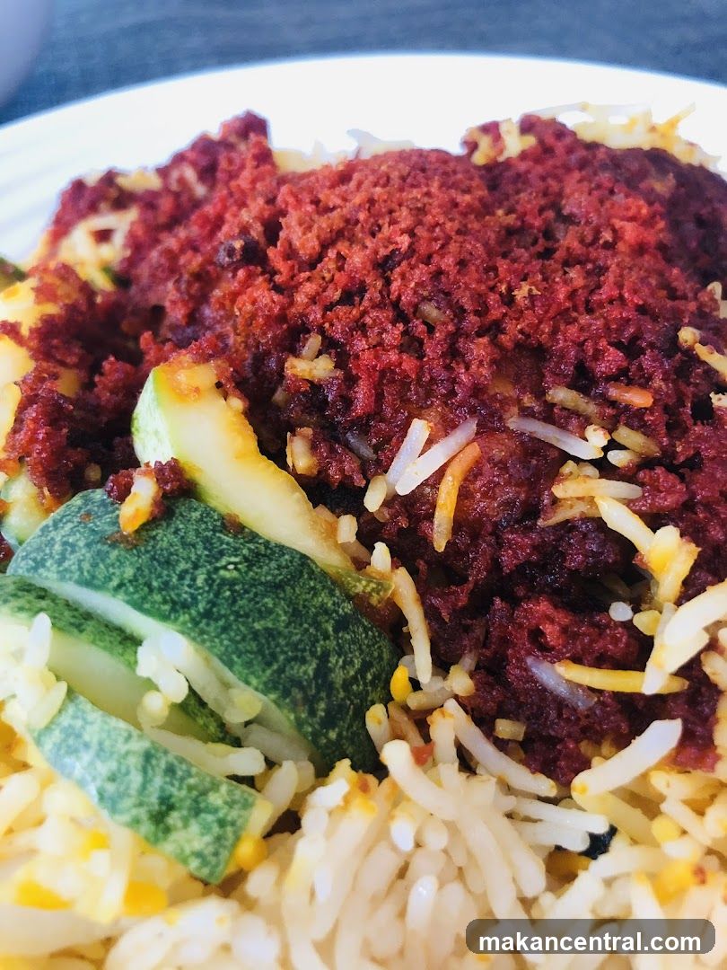 Close-up of a dish with rice, meat, and vegetables.
