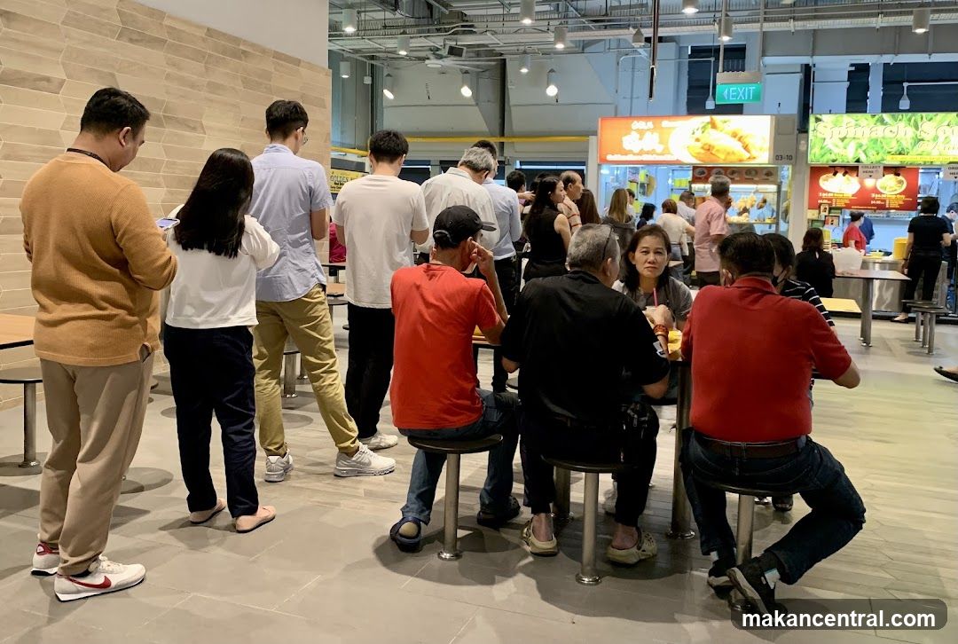 Food court with people queuing and dining
