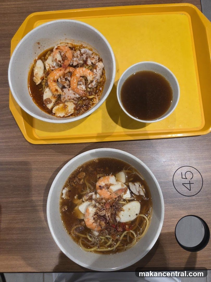 Two bowls of noodles with shrimp and fish cakes