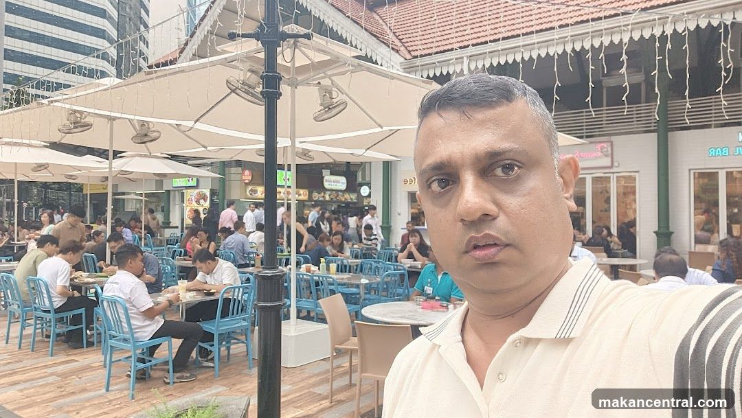 Man taking a selfie in an outdoor food court