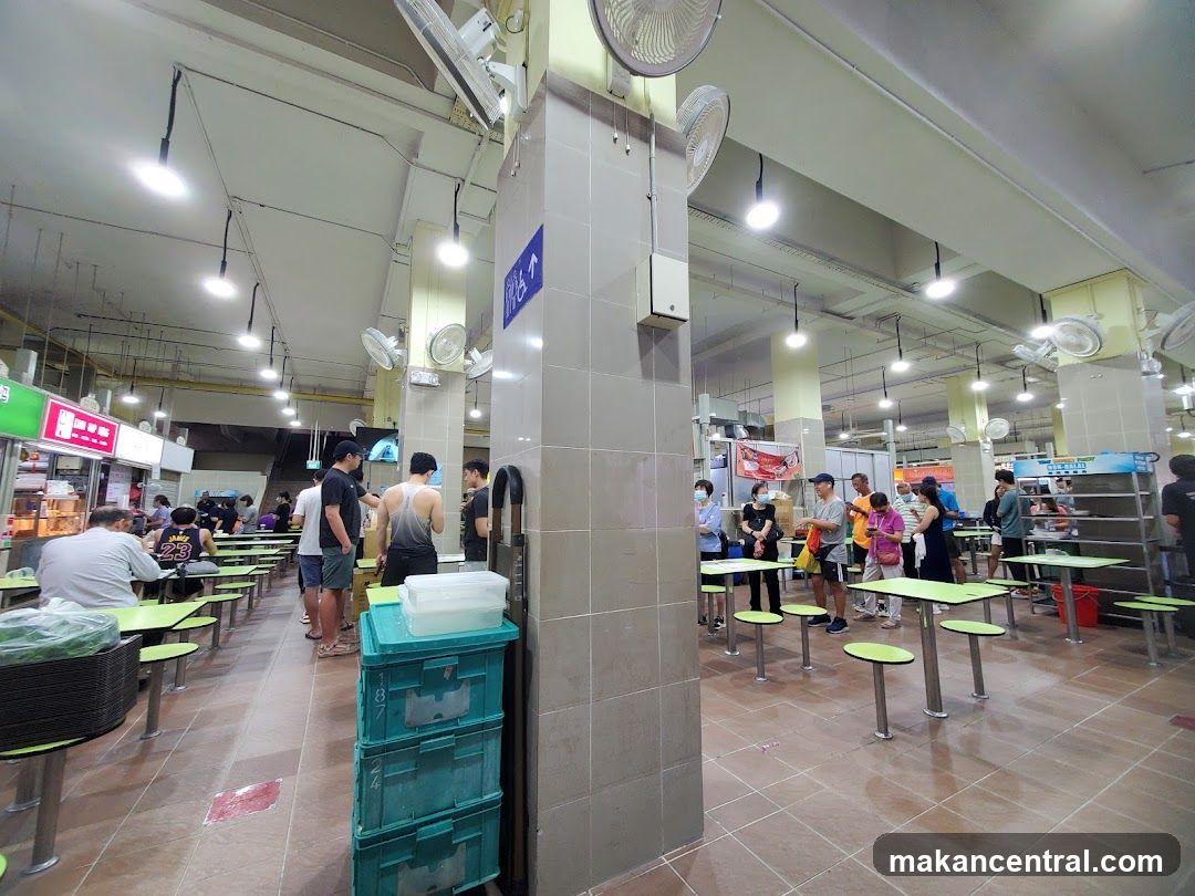 Food court with people dining and queuing