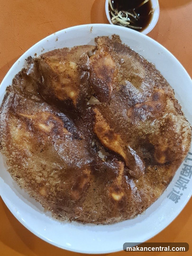 Pan-fried dumplings with dipping sauce