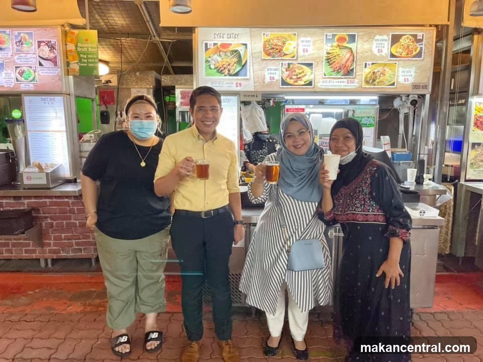 People Posing at a Food Stall