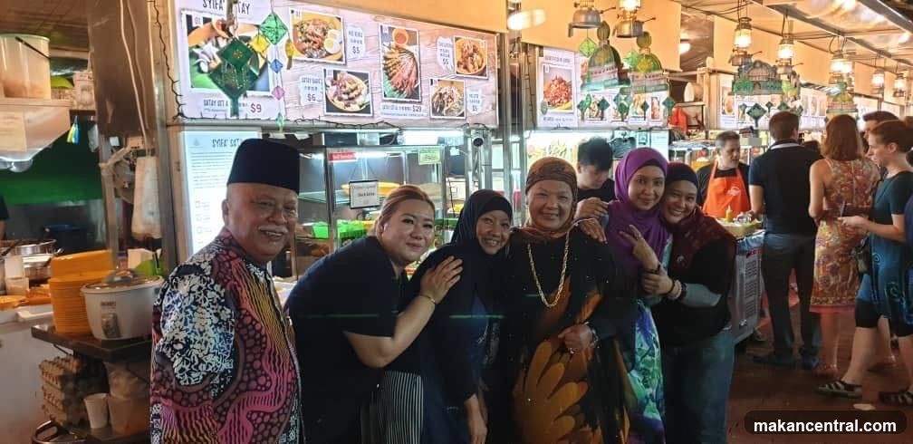 Group posing in front of food stalls