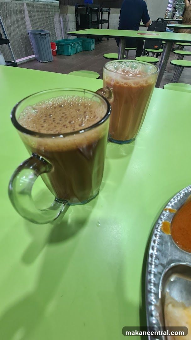 Two cups of milk tea on a green table