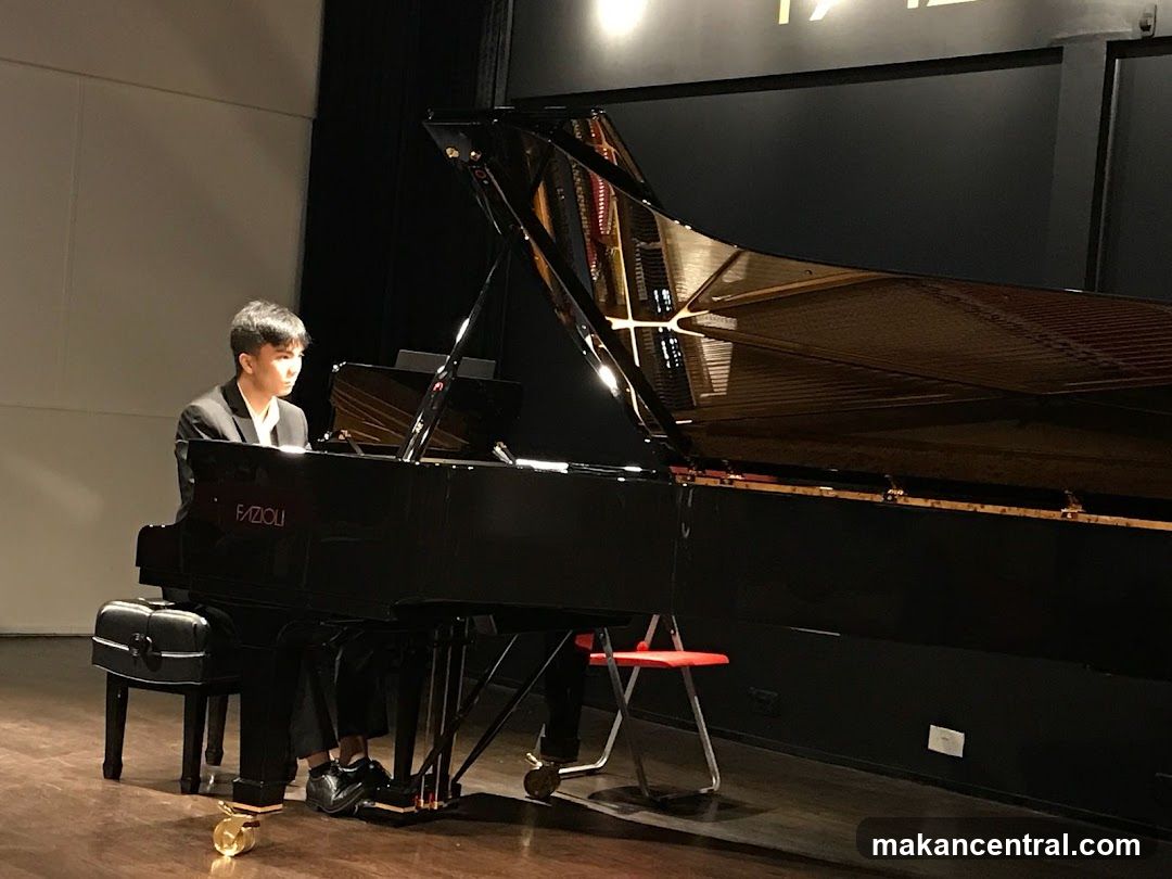 Pianist playing a grand piano