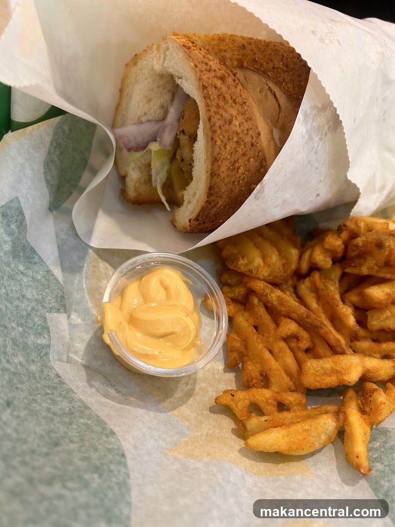 Sub sandwich with fries and dipping sauce